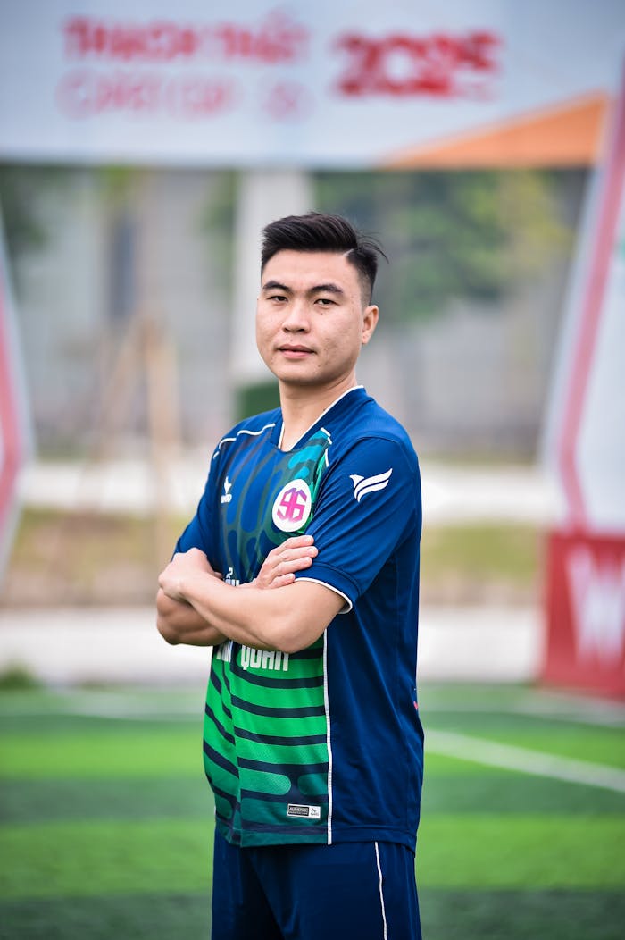 Portrait of a football player on a field in Hanoi, emphasize on sportsmanship.